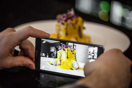Chef taking a photo of lunch with smartphoneの写真素材
