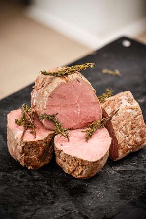 Pieces of a boiled beef meat on the black cutting boardの写真素材