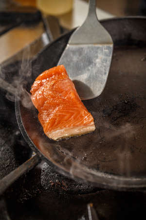 Fresh slice of salmon in the frying panの写真素材