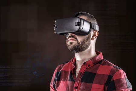 Young bearded man wearing virtual reality glasses