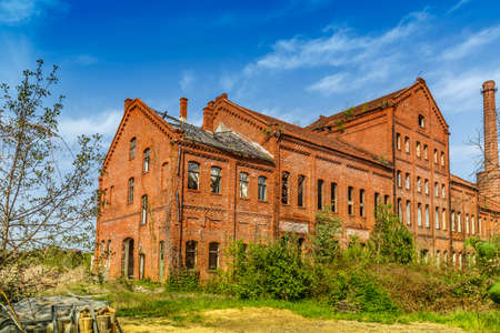 Abandoned urban brick building with broken windowsの写真素材