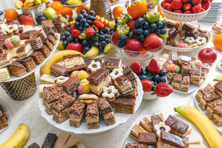 Dessert table for a party, cake and fruitの写真素材