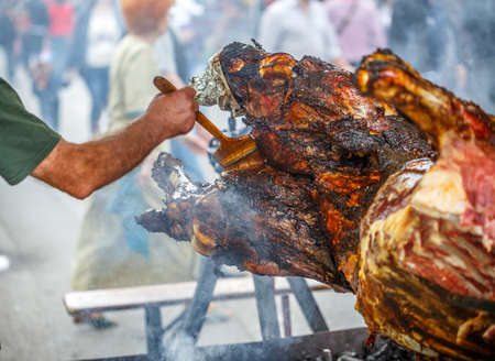 Barbecue picnic at country fair. Beef meat at rolling skewerの写真素材