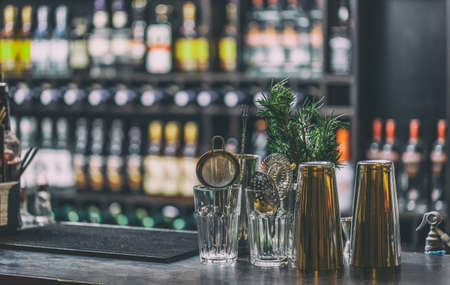 Classic bar counter with bottles in blurred backgroundの写真素材