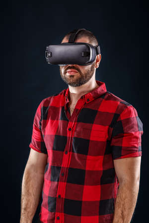 Young man using VR glasses headsetの写真素材