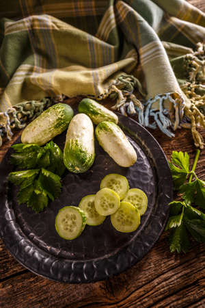 Still life of fresh whole and sliced cucumbersの写真素材