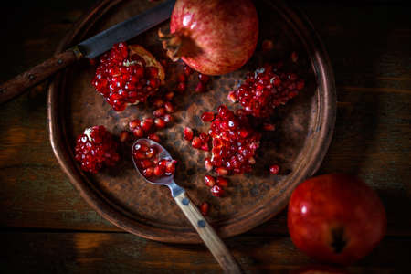 Broken and whole red ripe juicy pomegranatesの写真素材