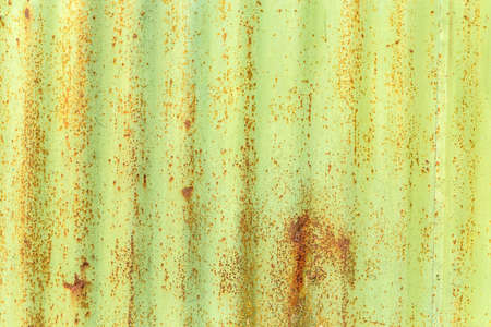 Corroded green metal background. Rusted green painted metal wall