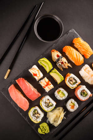 Various kinds of sushi served on black stoneの写真素材