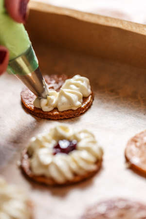 Pastry chef is decorating a mille-feuille cake with  whipped creamの写真素材