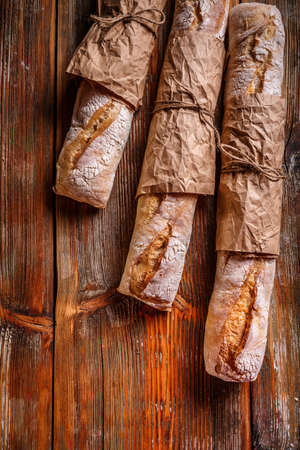 French bread baguettes on rustic wooden backgroundの写真素材