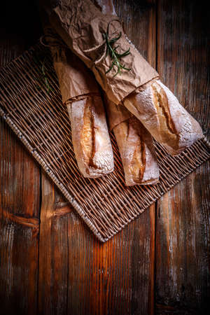 Top view of freshly baked French baguettes on old wooden backgroundの写真素材
