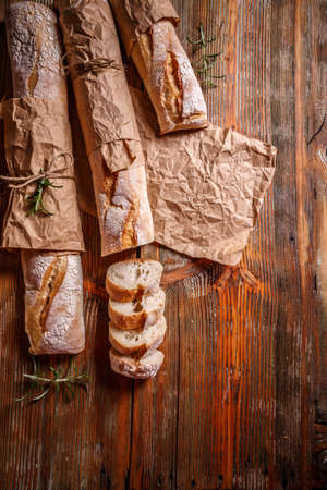 Top view of French baguettes on old wooden background