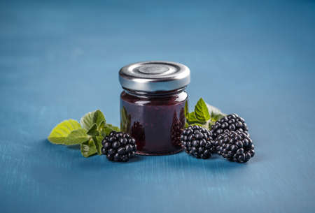 Homemade blackberry jelly on blue backgroundの写真素材