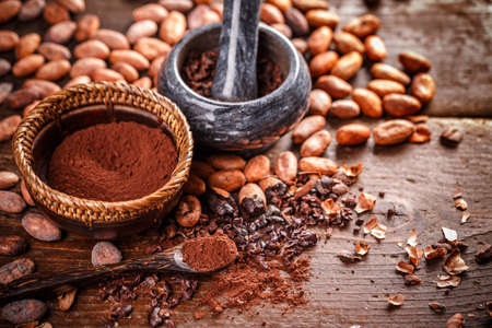 Still life of ground cocoa in mortar and pestleon wooden backgroundの写真素材