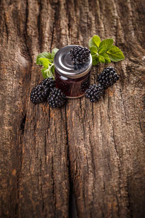Tasty blackberry jam and fresh berries, on rustic wooden backgroundの写真素材