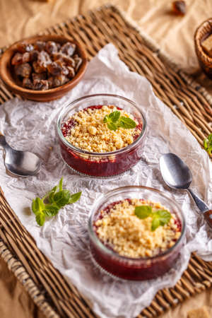 Pie crumble with red berries in small glass bowlの写真素材