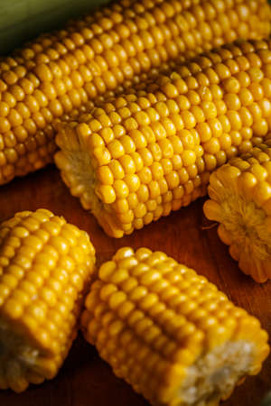 Cobs of sweet corn on a wooden tableの写真素材