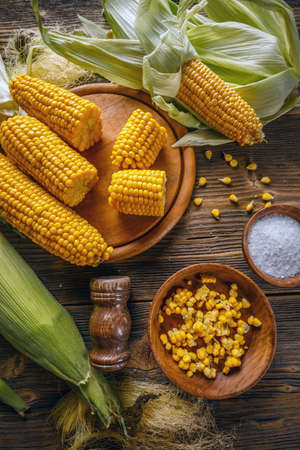 Top view of homemade golden corn cob with salt on tableの写真素材