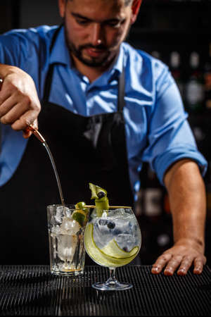 Bartender preparing a gin tonic cocktailの写真素材