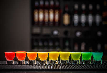 Rainbow color shots on the bar counterの写真素材