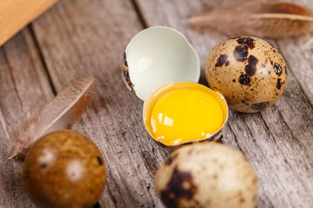 Close up of raw quail eggs on a rustic wooden tableの写真素材