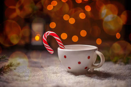 Dotted china cup with candy cane on Christmas style backgroundの写真素材