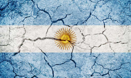 Argentina flag on dry earth ground texture backgroundの写真素材
