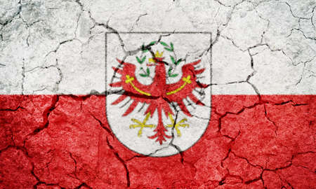 Tyrol, Austrian state flag on dry earth ground texture backgroundの写真素材