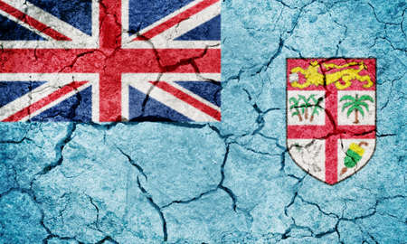 Republic of Fiji flag on dry earth ground texture backgroundの写真素材