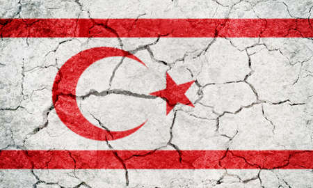 Turkish Republic of Northern Cyprus flag on dry earth ground texture backgroundの写真素材