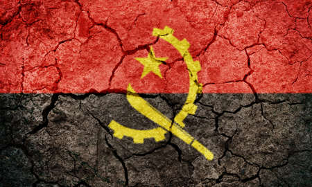 Angola flag on dry earth ground texture backgroundの写真素材