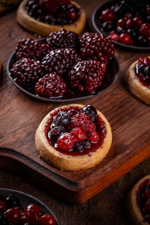 Homemade tartlets with cream and fresh berriesの写真素材