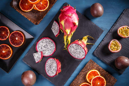 Tropical fruit concept, dragon fruit on black slateの写真素材