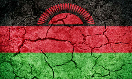 Republic of Malawi flag on dry earth ground texture backgroundの写真素材