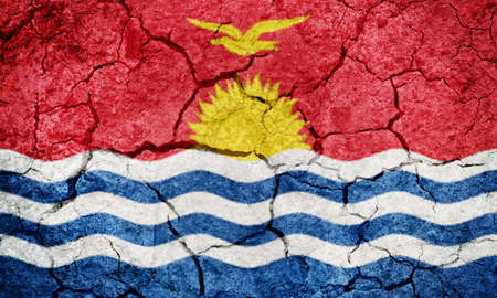 Republic of Kiribati flag on dry earth ground texture backgroundの写真素材