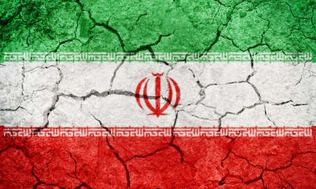  Islamic Republic of Iran flag on dry earth ground texture backgroundの写真素材