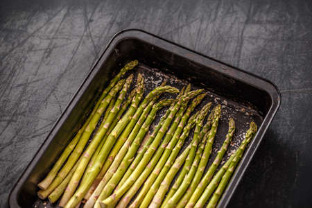  Raw asparagus on baking sheet ready to cookの写真素材