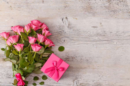 Valentines day background with pink roses over wooden table. Top view with copy spaceの写真素材