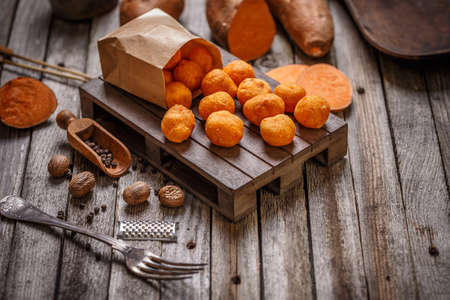 Fried sweet potato balls on wooden backgroundの写真素材