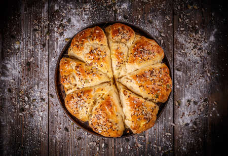 Bread buns with various seeds on vintage wooden tableの写真素材