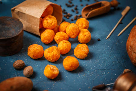 Sweet potato croquettes in a paper bag on blue backgroundの写真素材