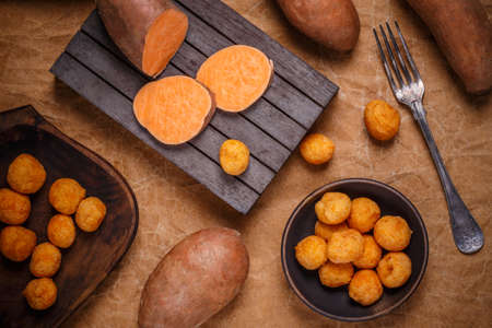 Thai fried sweet potato balls on brown backgroundの写真素材