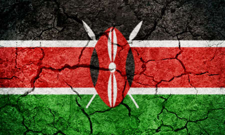 Republic of Kenya flag on dry earth ground texture backgroundの写真素材