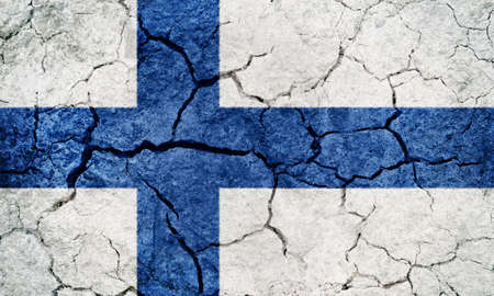 Republic of Finland flag on dry earth ground texture backgroundの写真素材