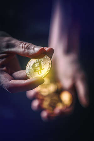Man holding in hand symbol of crypto currency, selective focus