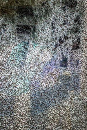 Broken tempered glass texture on a dark background