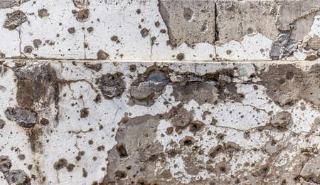 Concrete wall background with bullet hole, potholes from weapon shootingの写真素材