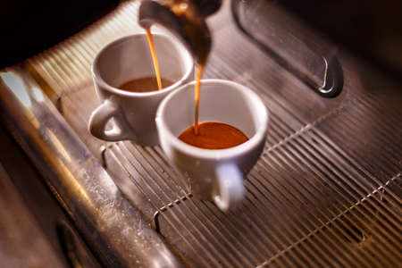 Espresso machine making coffee, golden espresso flowing.の写真素材