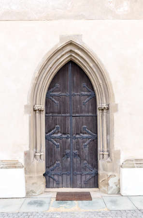Old church or castle front door with iron ornamentsの写真素材